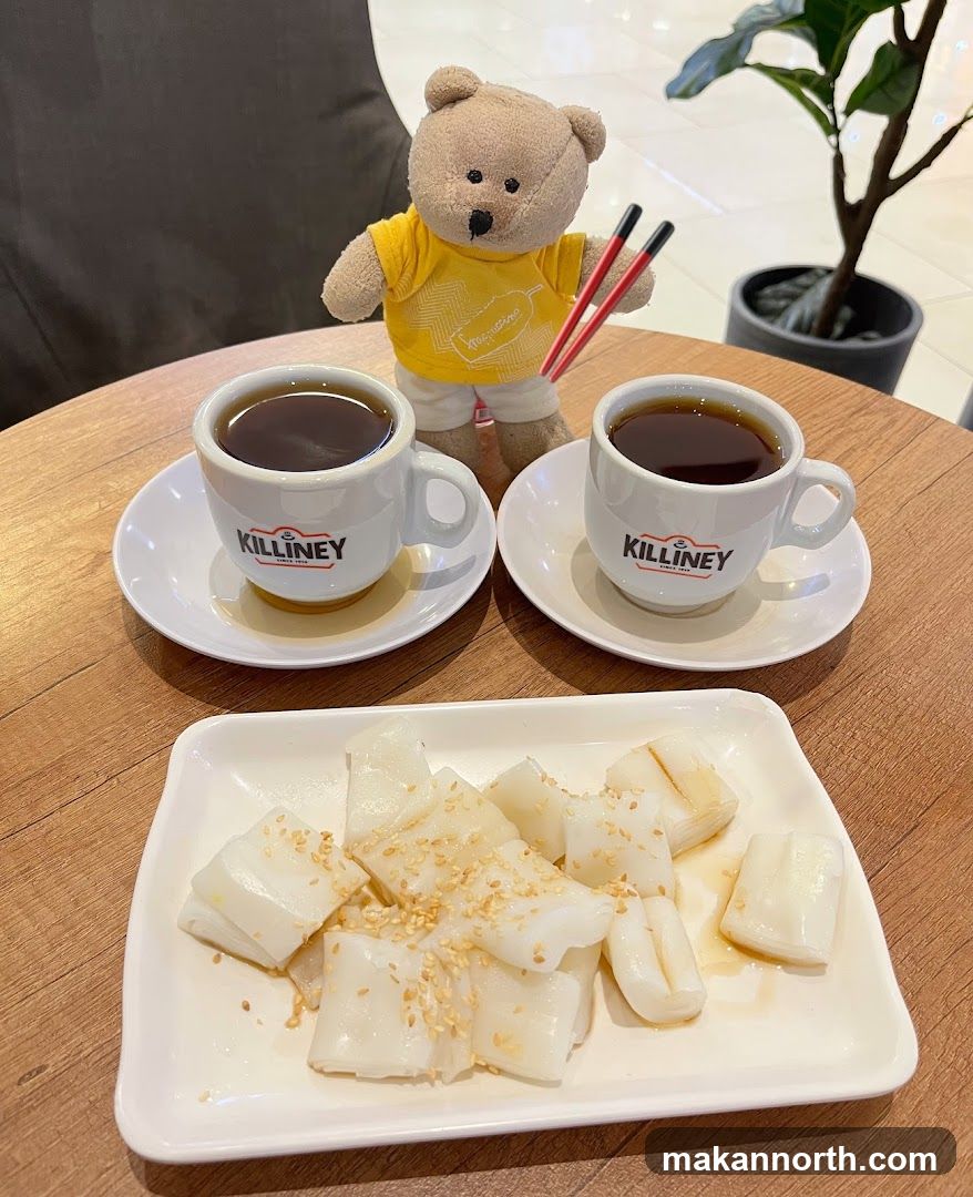Bear toy with coffee and rice noodle rolls