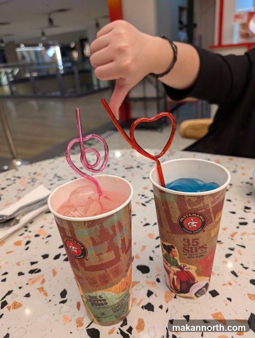 Two drinks with heart-shaped straws
