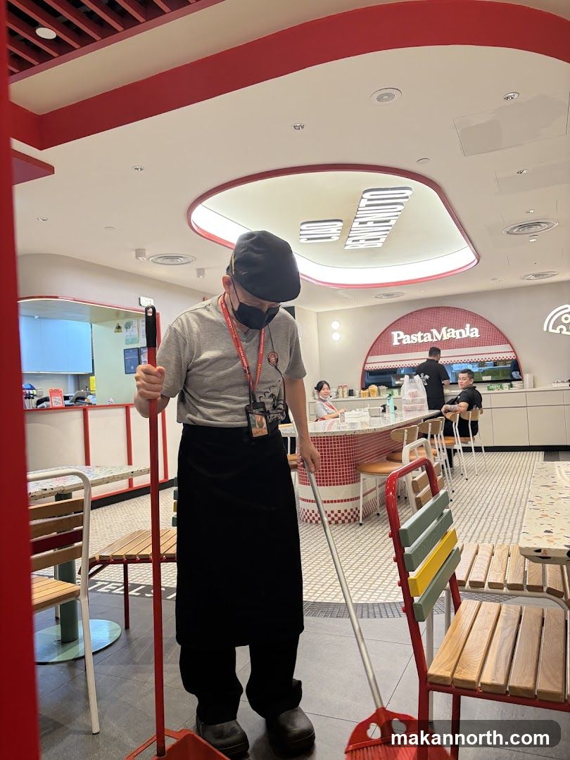 Staff member cleaning restaurant