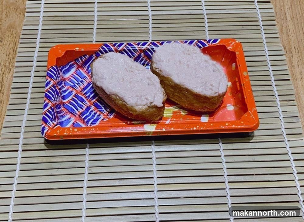 Two pieces of sushi on a tray