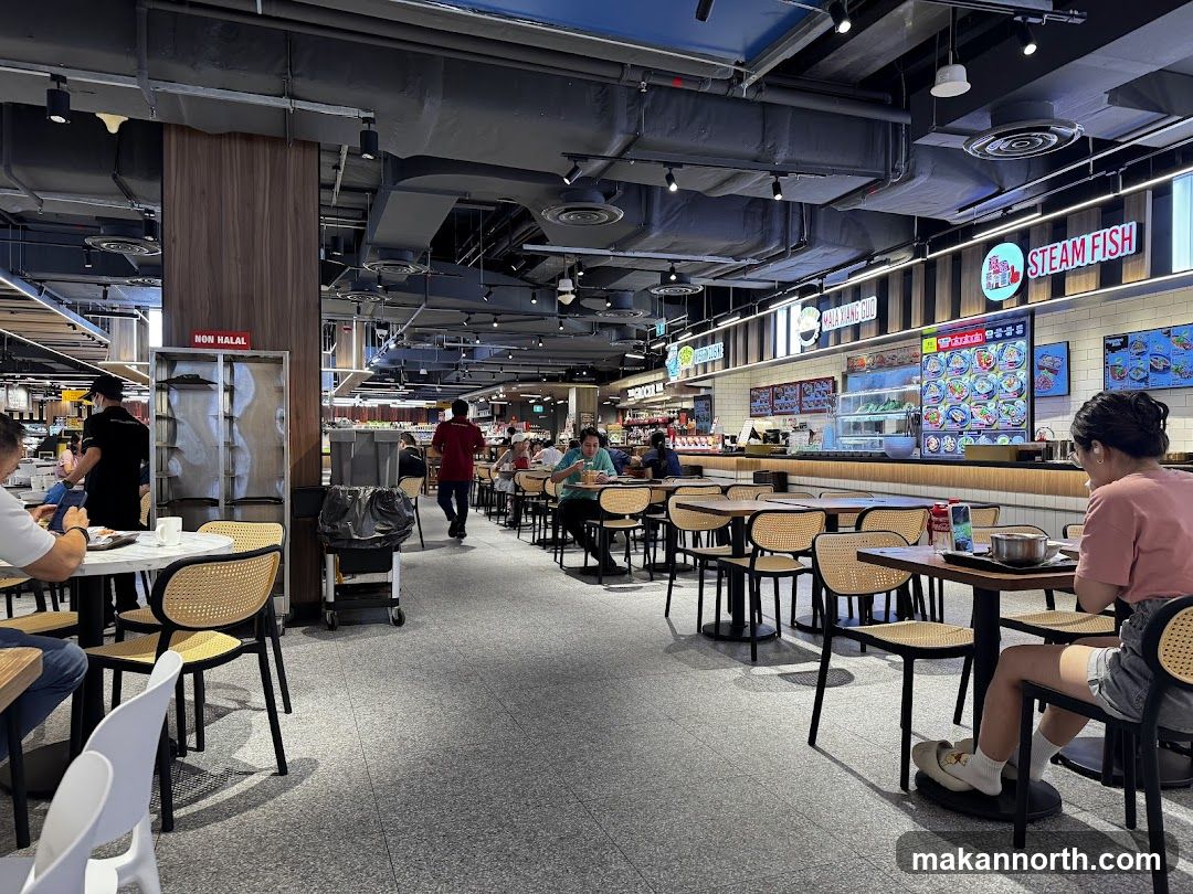 Food court with various stalls and seating areas
