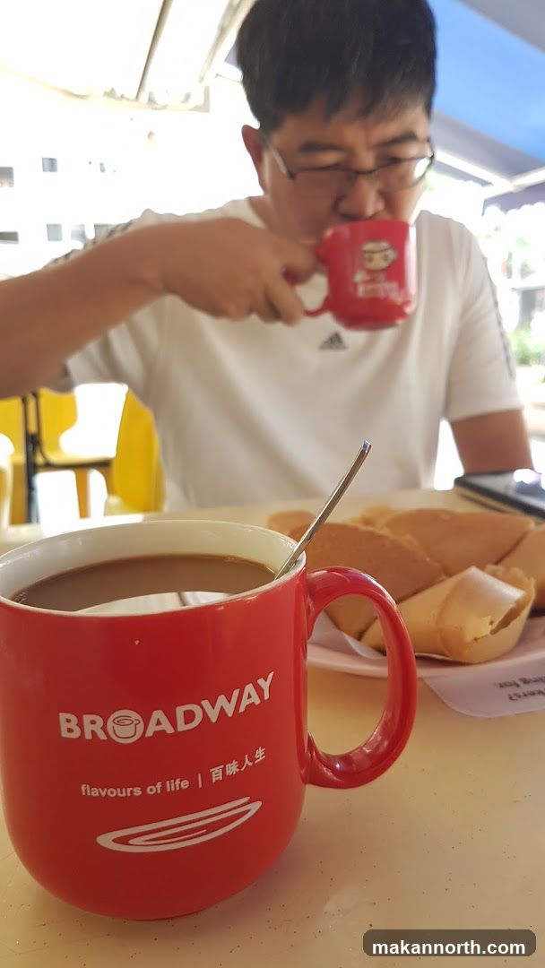 Man drinking coffee with pancakes