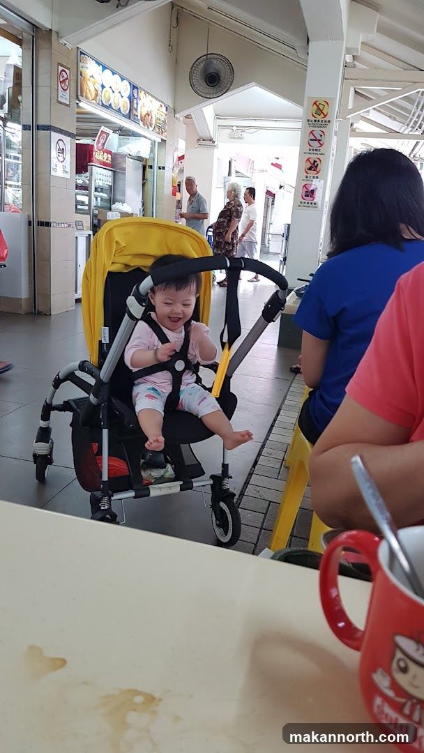 Baby in Stroller at Food Stall