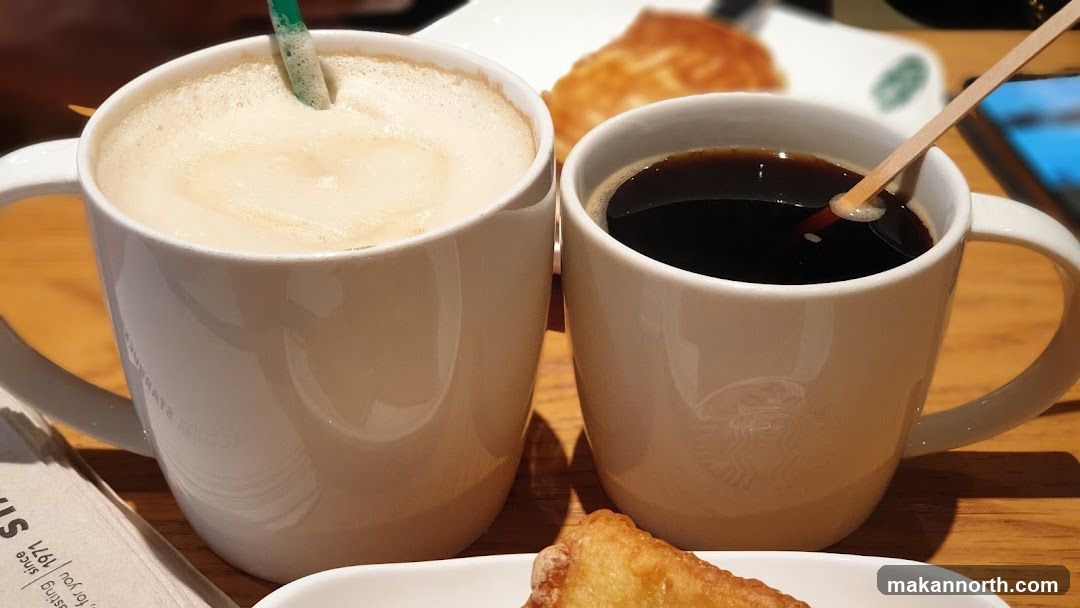 Two coffee cups and pastry