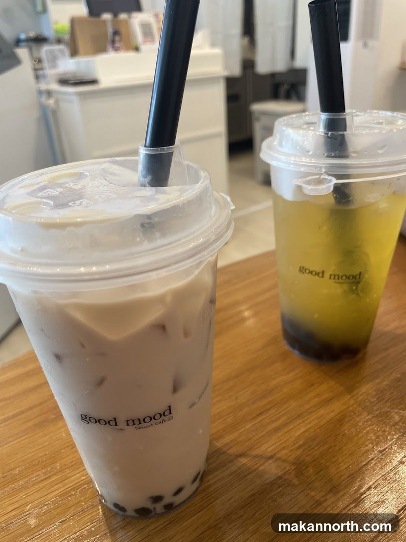 Two bubble tea drinks on a wooden table