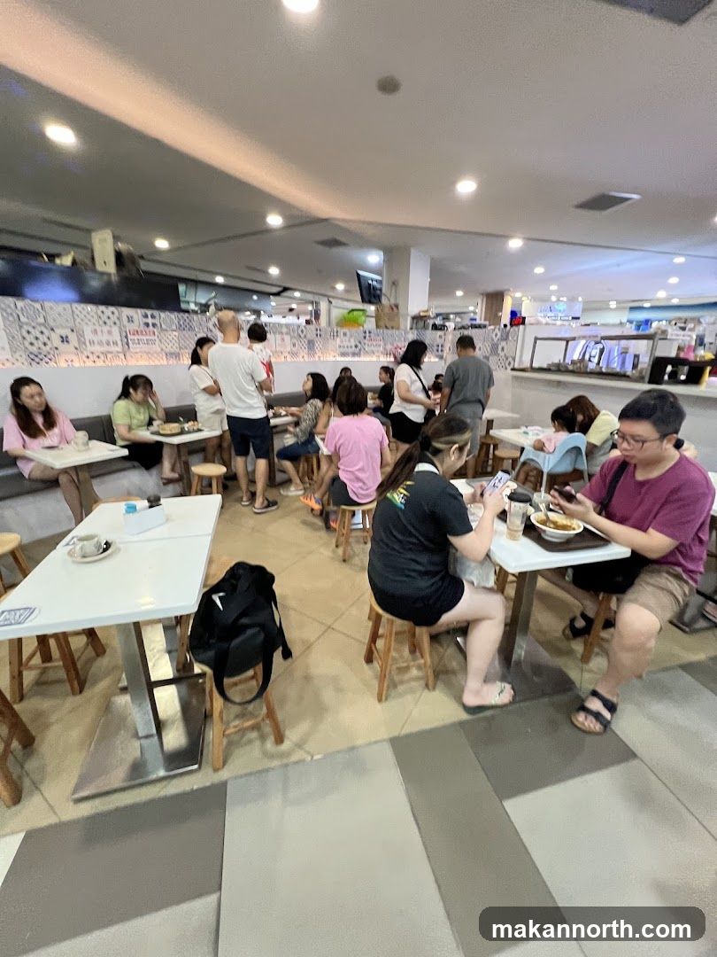People eating at tables in a food court