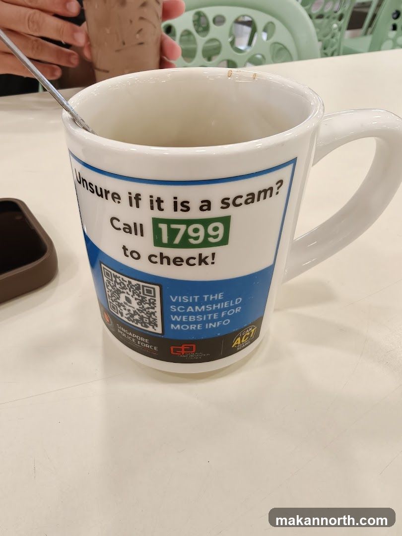 Mug with scam alert information