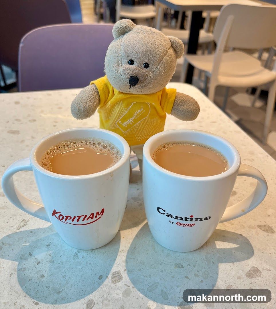 Two cups of tea with a teddy bear