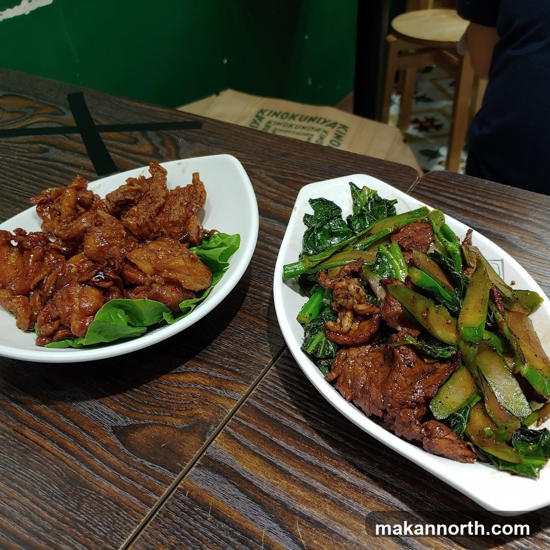 Two dishes of food on a wooden table
