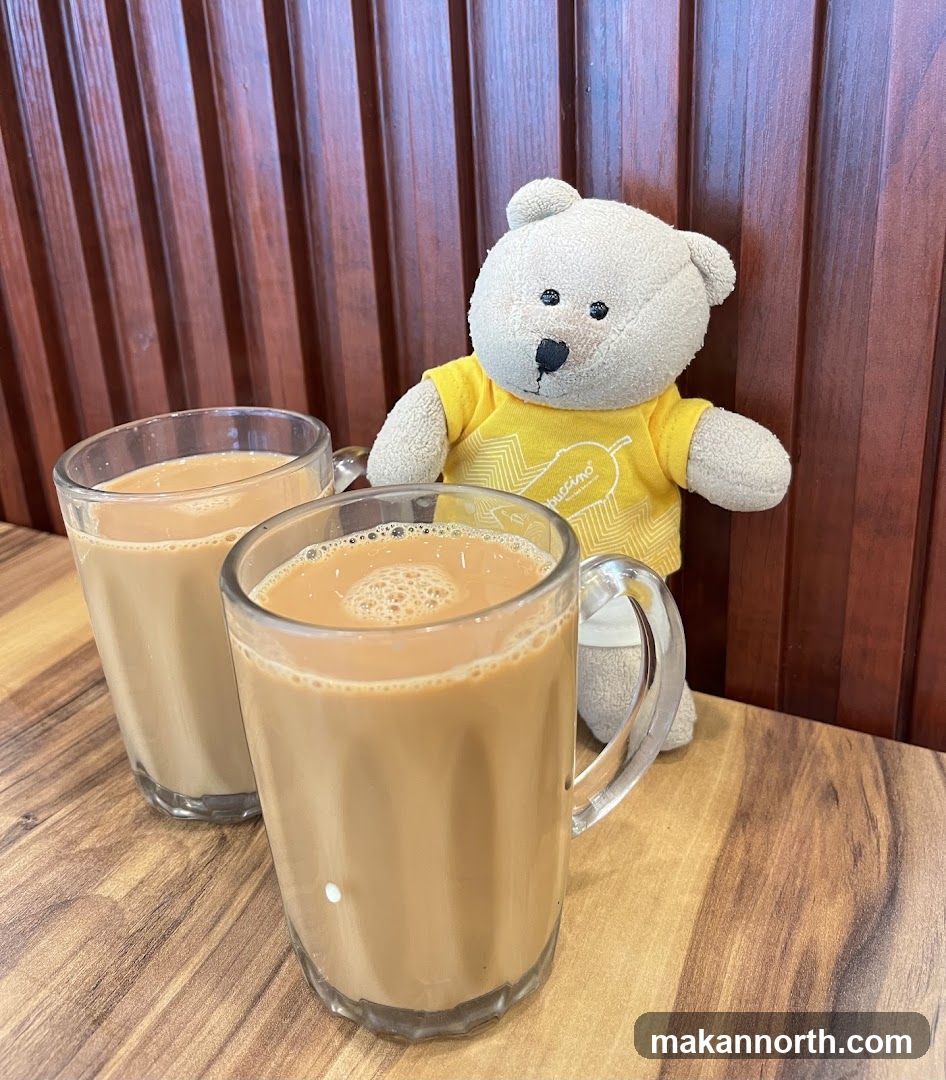 Two cups of milk tea with a teddy bear