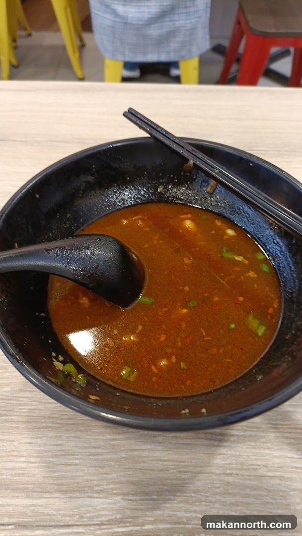 Bowl of Soup with Spoon and Chopsticks