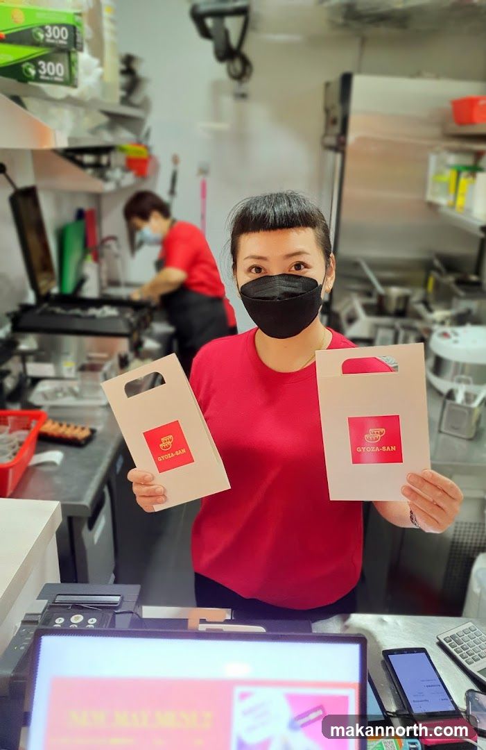 Staff holding branded bags