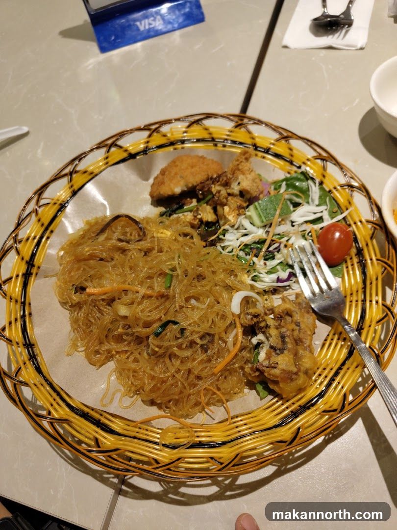 Noodle Dish with Fried Items and Salad