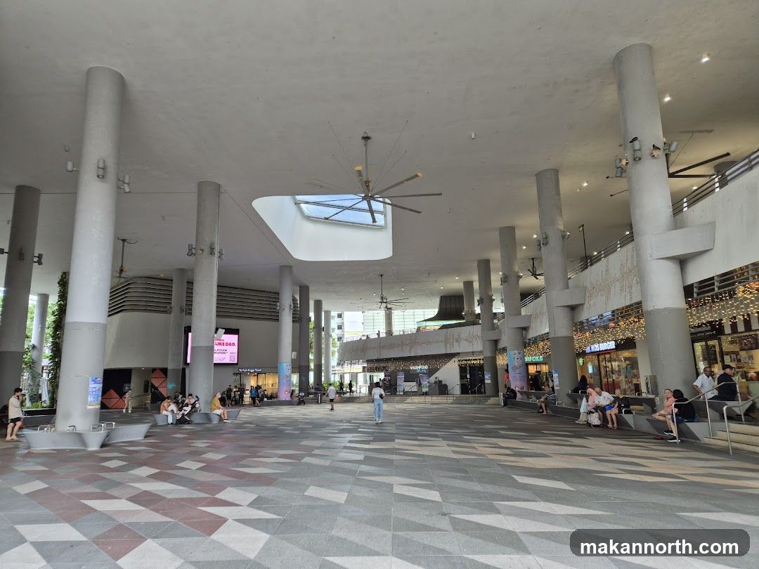 Outdoor mall plaza with shops and seating