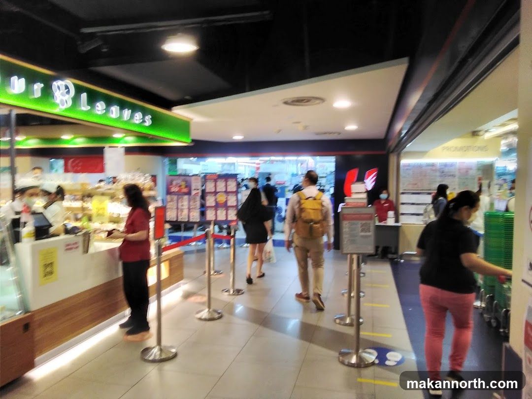 Indoor shopping area with food stalls and promotions