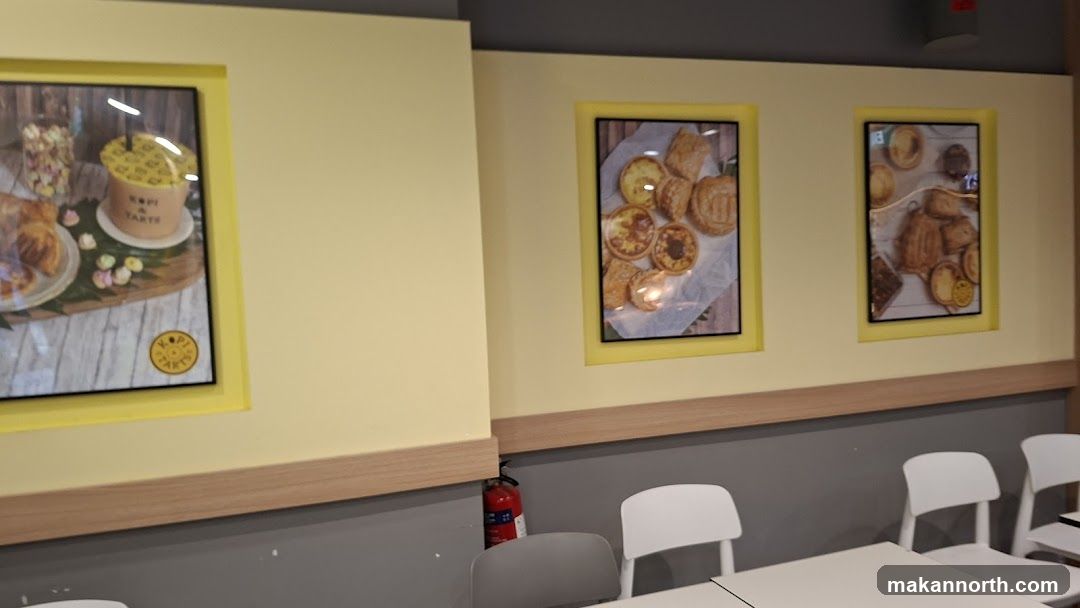 Interior of a cafe with framed pictures of pastries and drinks