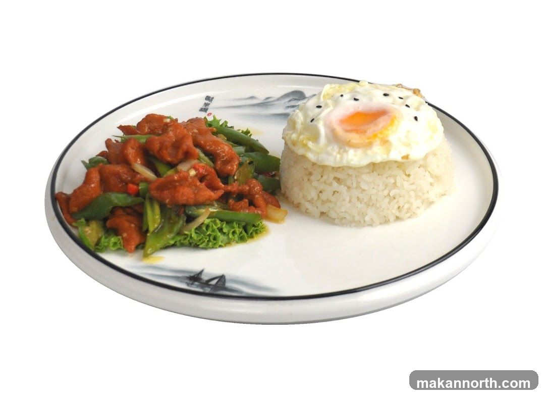Stir-fried meat with vegetables and rice with fried egg