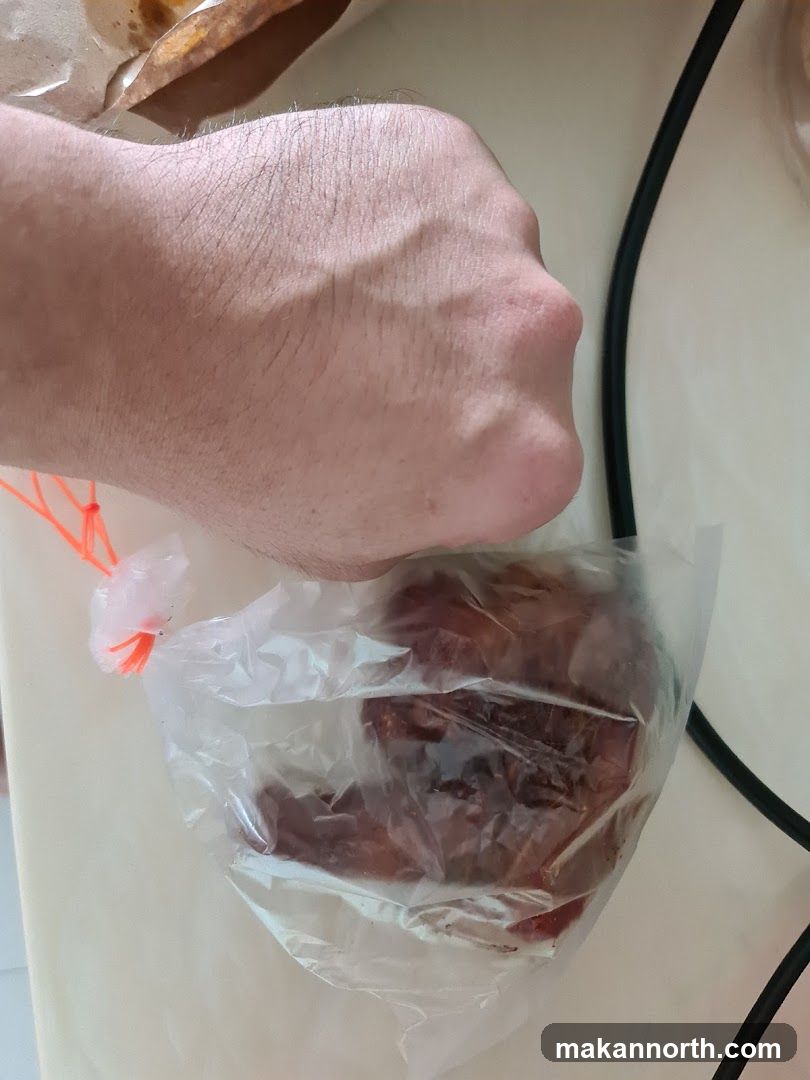 Hand holding food in plastic bag