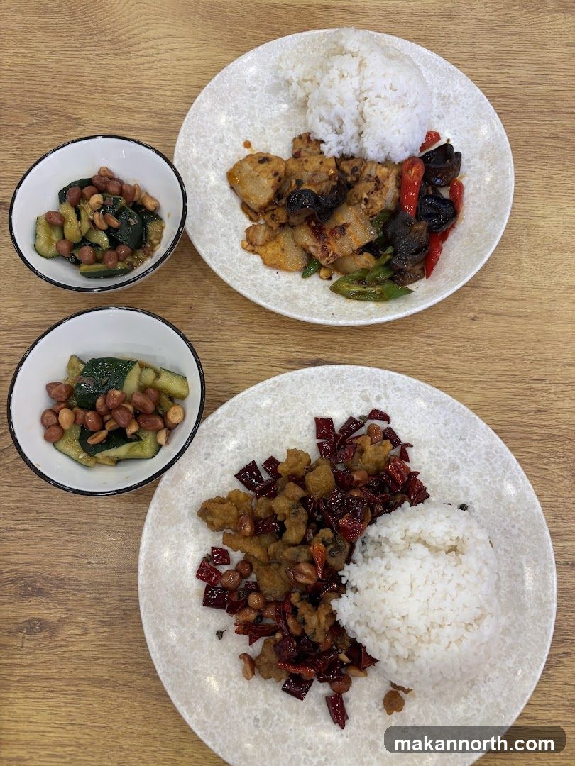 Two plates of Chinese food with rice and side dishes
