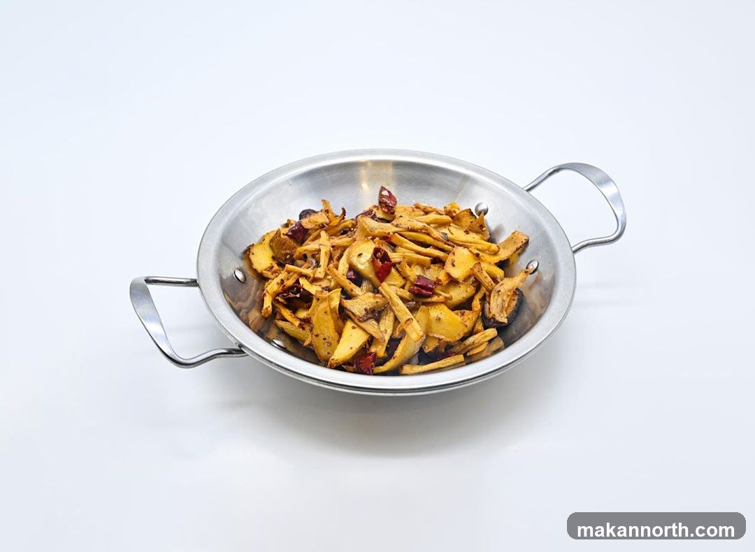 Stir-fried dish in a metal bowl