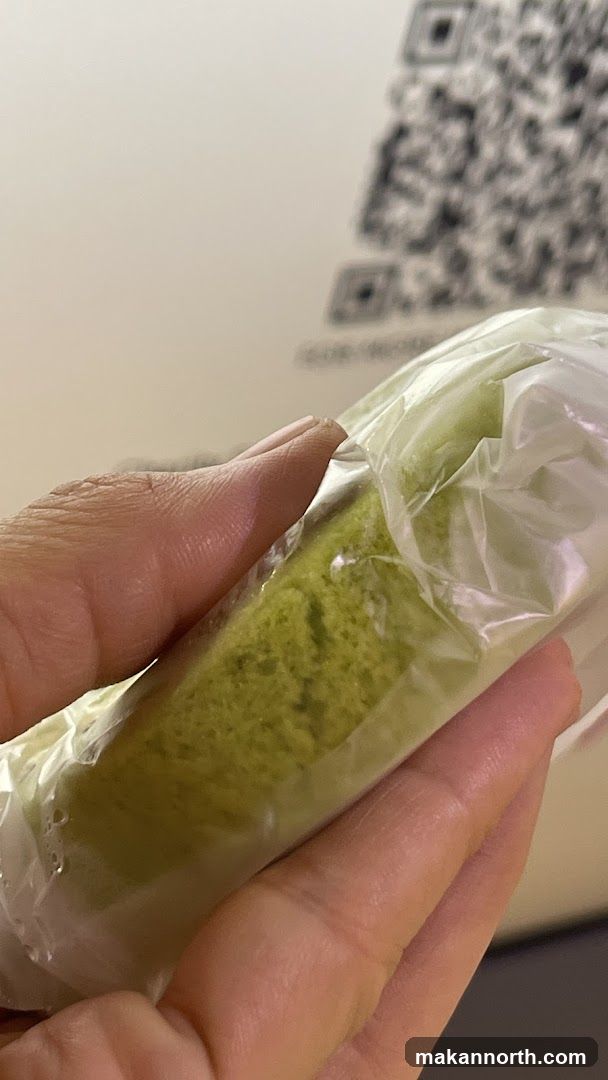 Hand holding a green cake roll