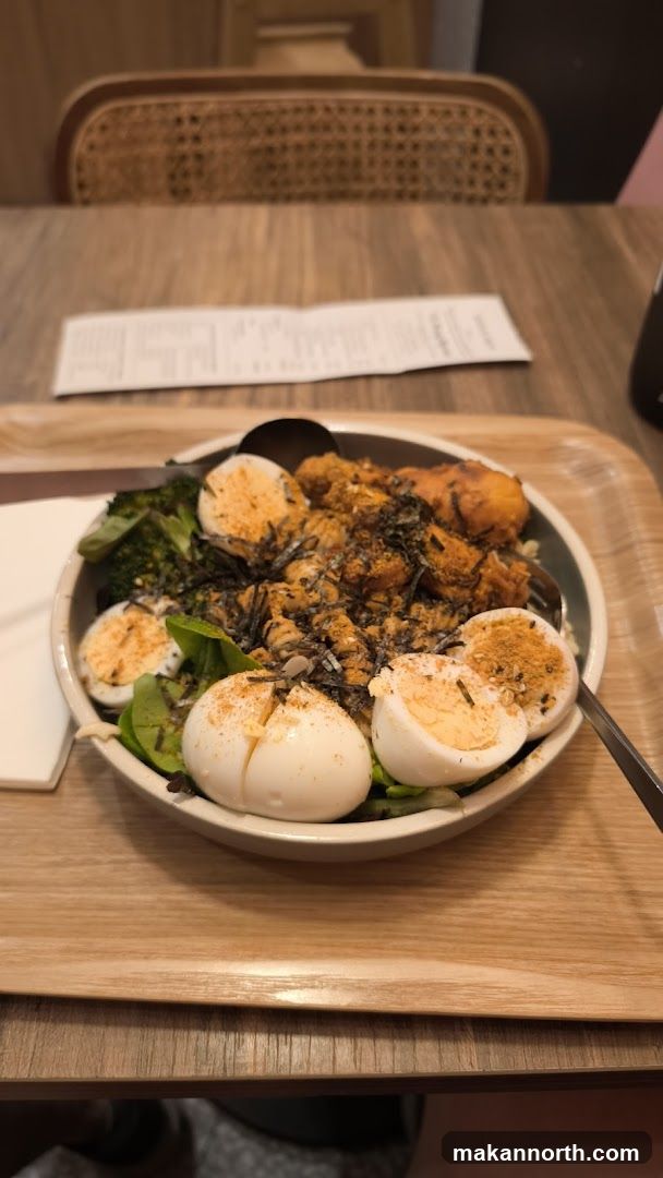 Bowl of food with eggs and broccoli