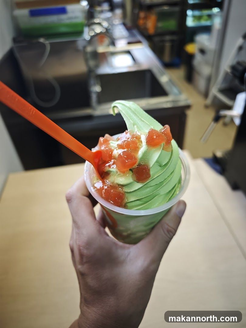Green soft serve ice cream with toppings