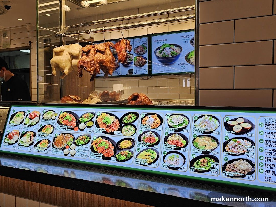 Food display with roasted chickens and menu