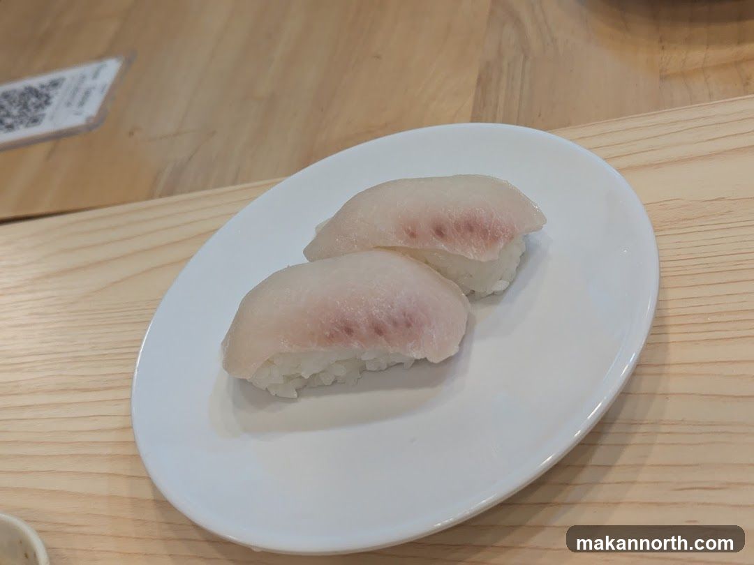 Two pieces of white fish sushi