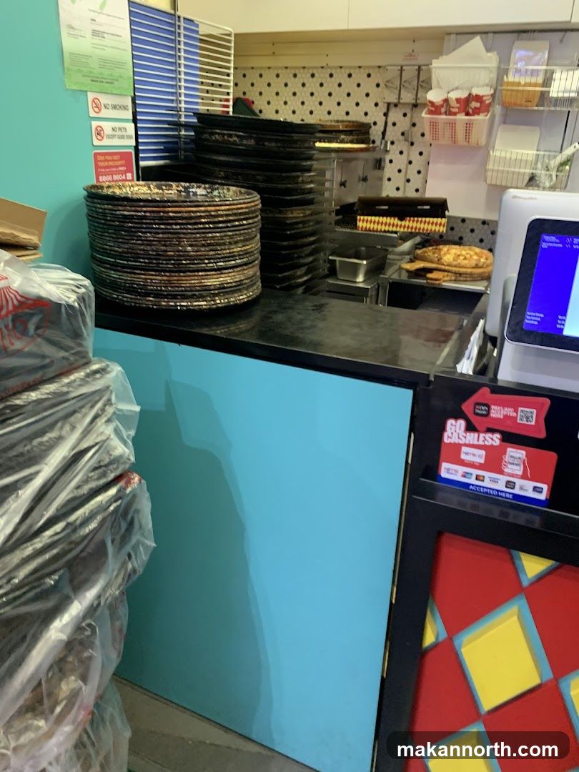 Counter with Pizza Trays and Cash Register