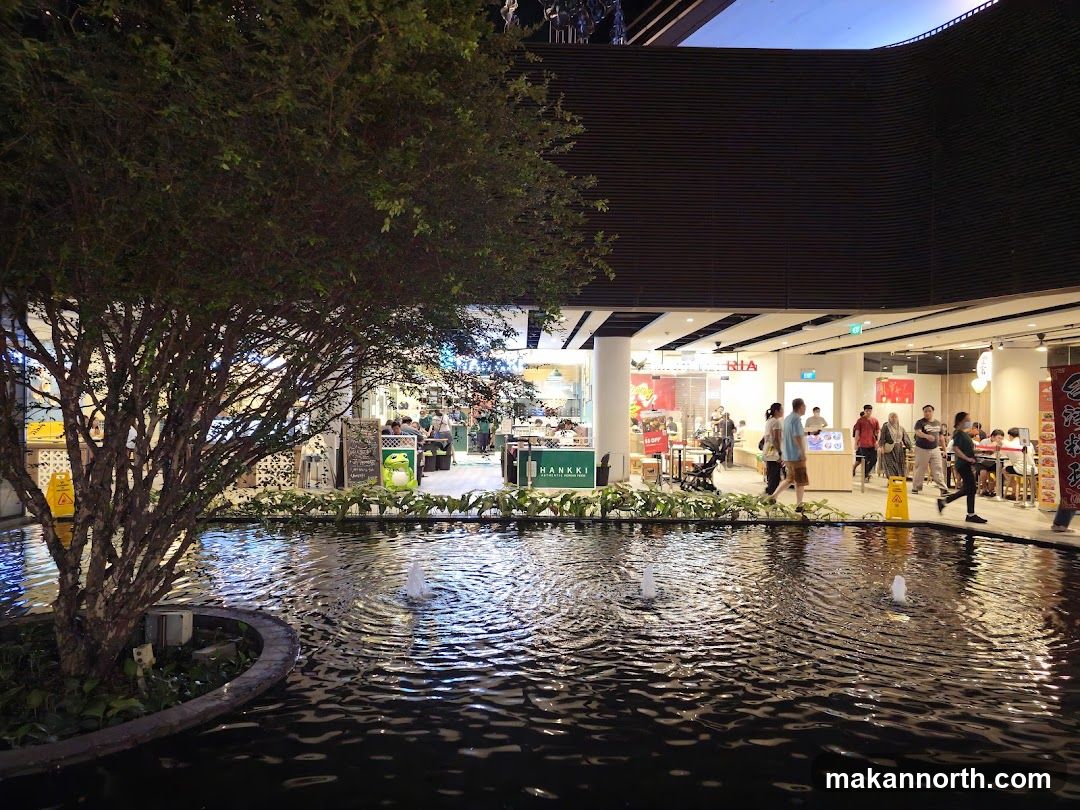 Indoor shopping mall with a water feature and food court