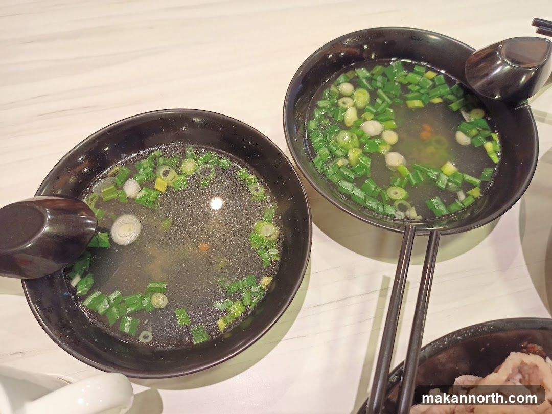 Two bowls of soup with chopped green onions