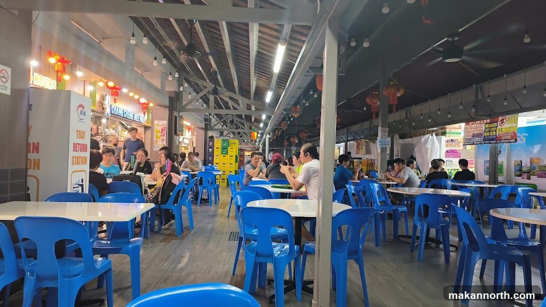 Food court with blue chairs and tables