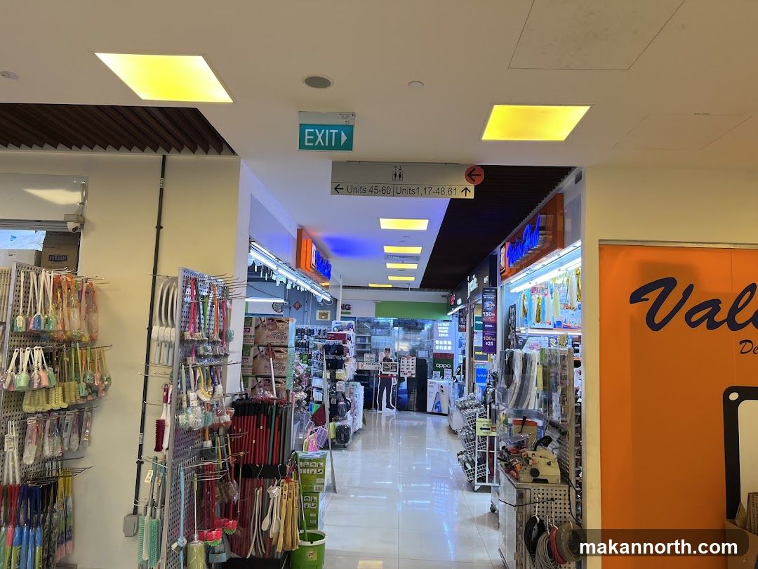 Indoor shopping aisle with cleaning supplies and electronics