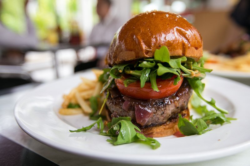 A stacked burger with juicy patty and fresh toppings, the style of burger served at ICG Chicken and Burger in Yishun Industrial Street 1