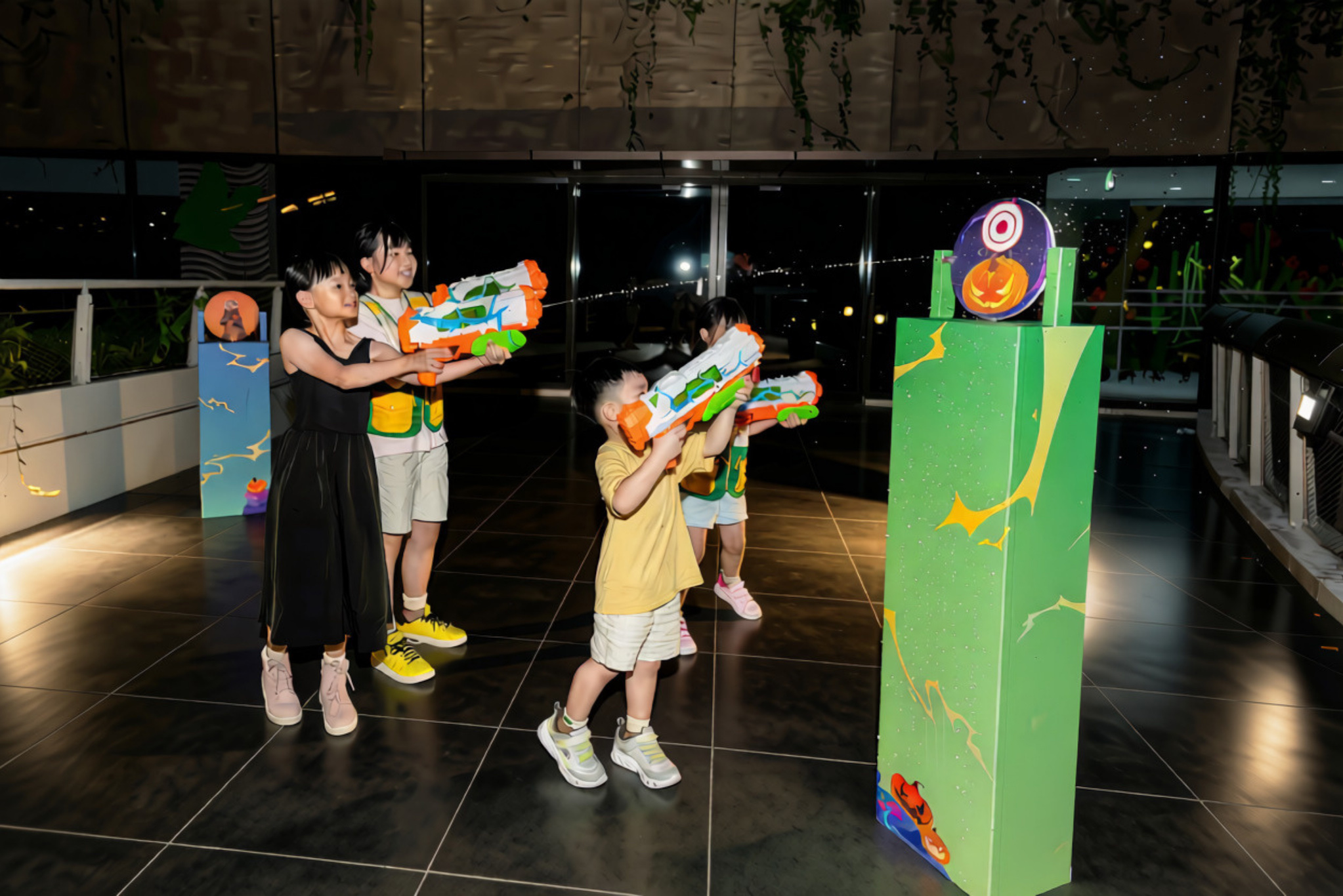 Children playing pumpkin carnival games at The Mischief Within in Curiosity Cove Mandai