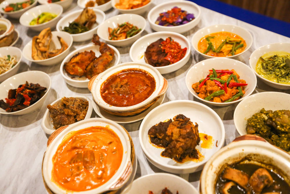 Nasi padang counter with assorted dishes including beef rendang, fried chicken and vegetable sides, the style of spread at Pondok by June Zack in Sembawang