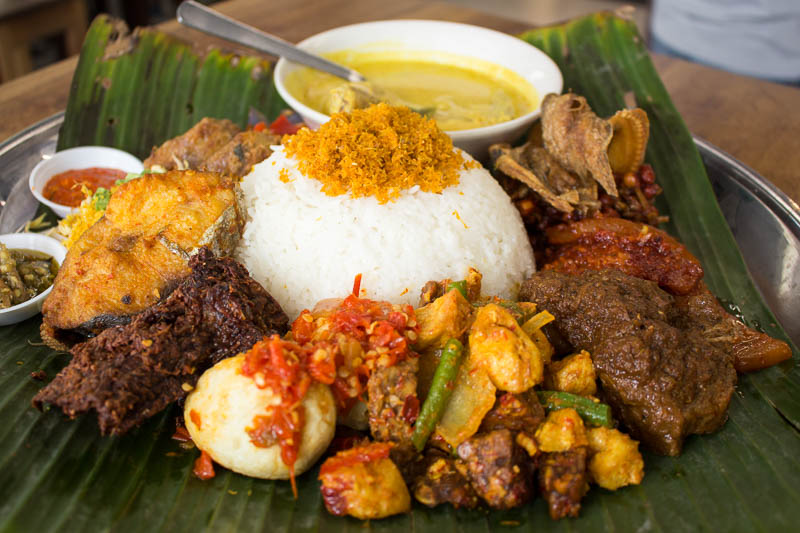 A nasi padang spread with rice, beef rendang, fried chicken and vegetable sides, the kind of platter available at Pondok by June Zack in Sembawang