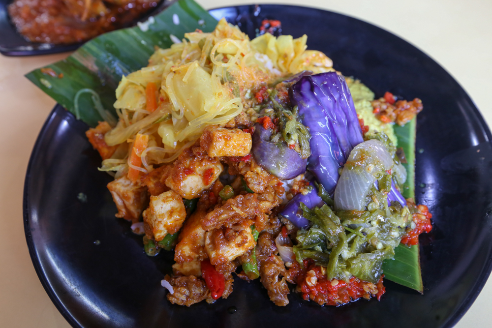 Close-up of nasi padang dishes including beef rendang and sambal squid on a plate, the signature orders at Pondok by June Zack in Sembawang
